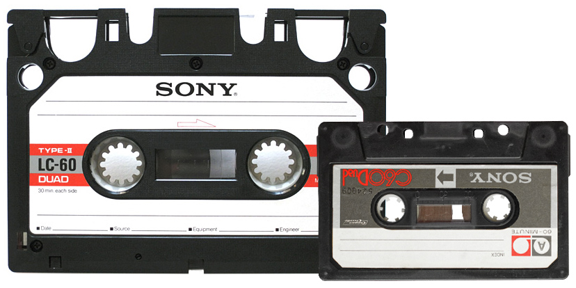 An Elcaset cassette beside a compact cassette, showing the Elcaset at about twice the size