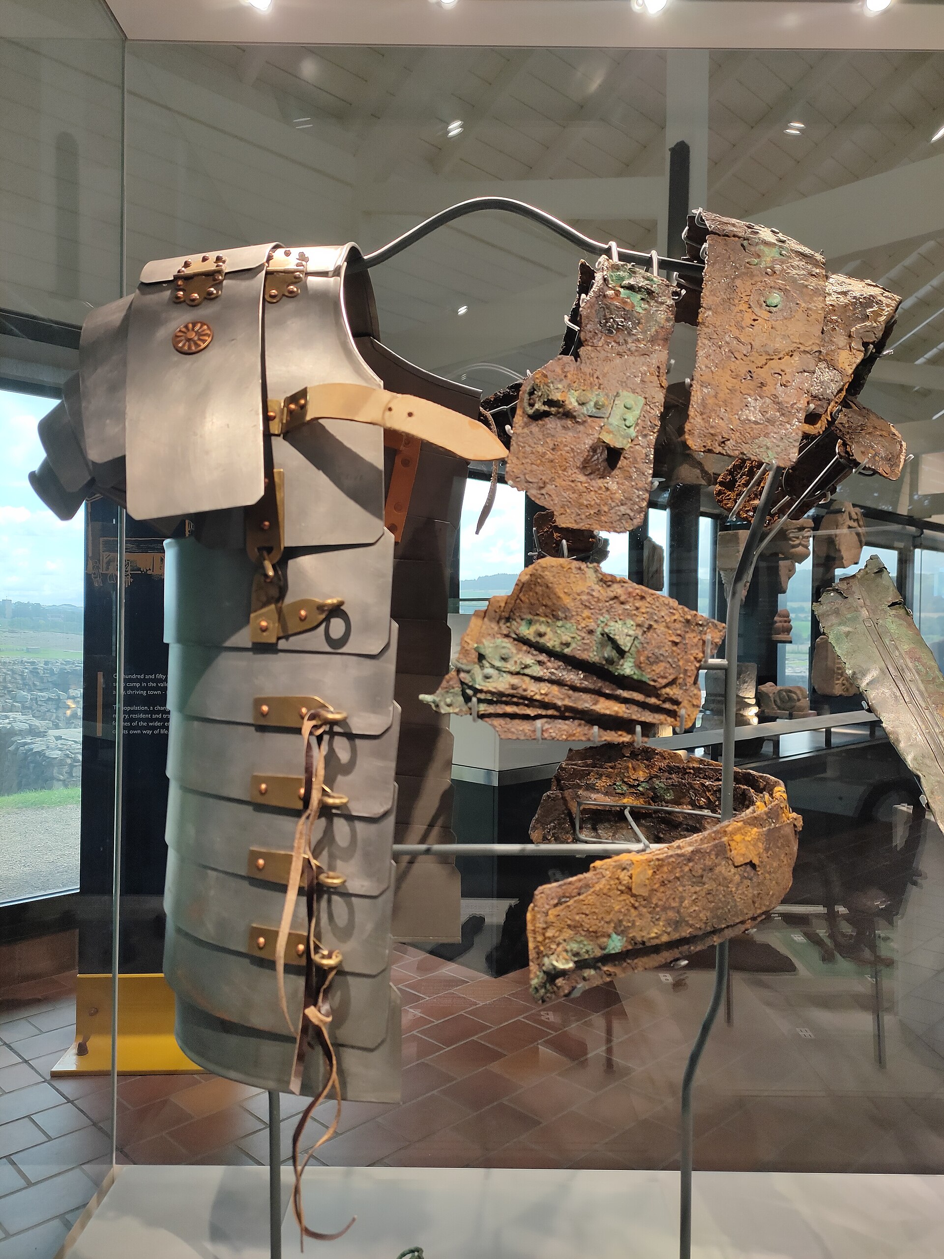 Remains of lorica segmentata from the Corbridge Hoard displayed beside a recreation in the Corbridge Roman Site museum.