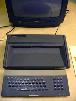 A Tandata Td1400 Prestel terminal as supplied by the Nottingham Building Society for its home banking service: a remote keyboard and docking station that connected to a television and a phone line.