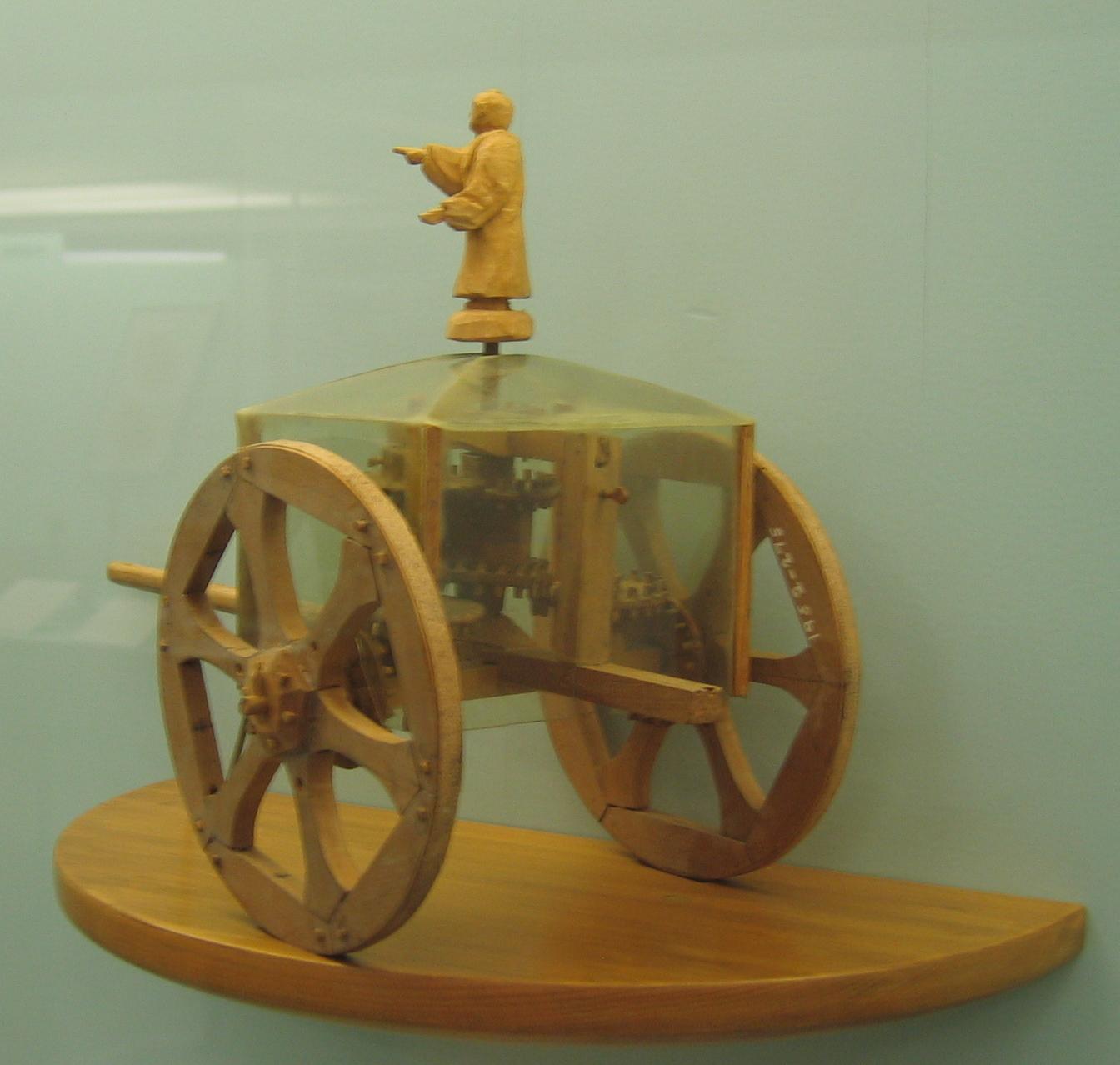 A modern conjectural model of a south-pointing chariot, with a pointing figure on a two-wheeled carriage, in the Science Museum, London