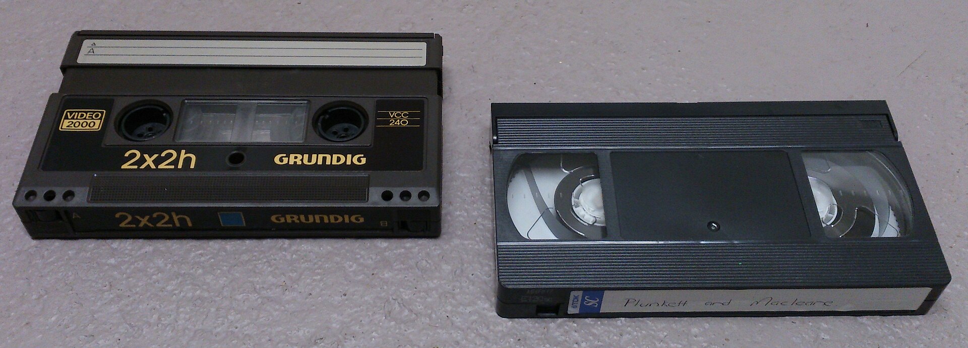 A Video 2000 cassette compared in size with a VHS cassette