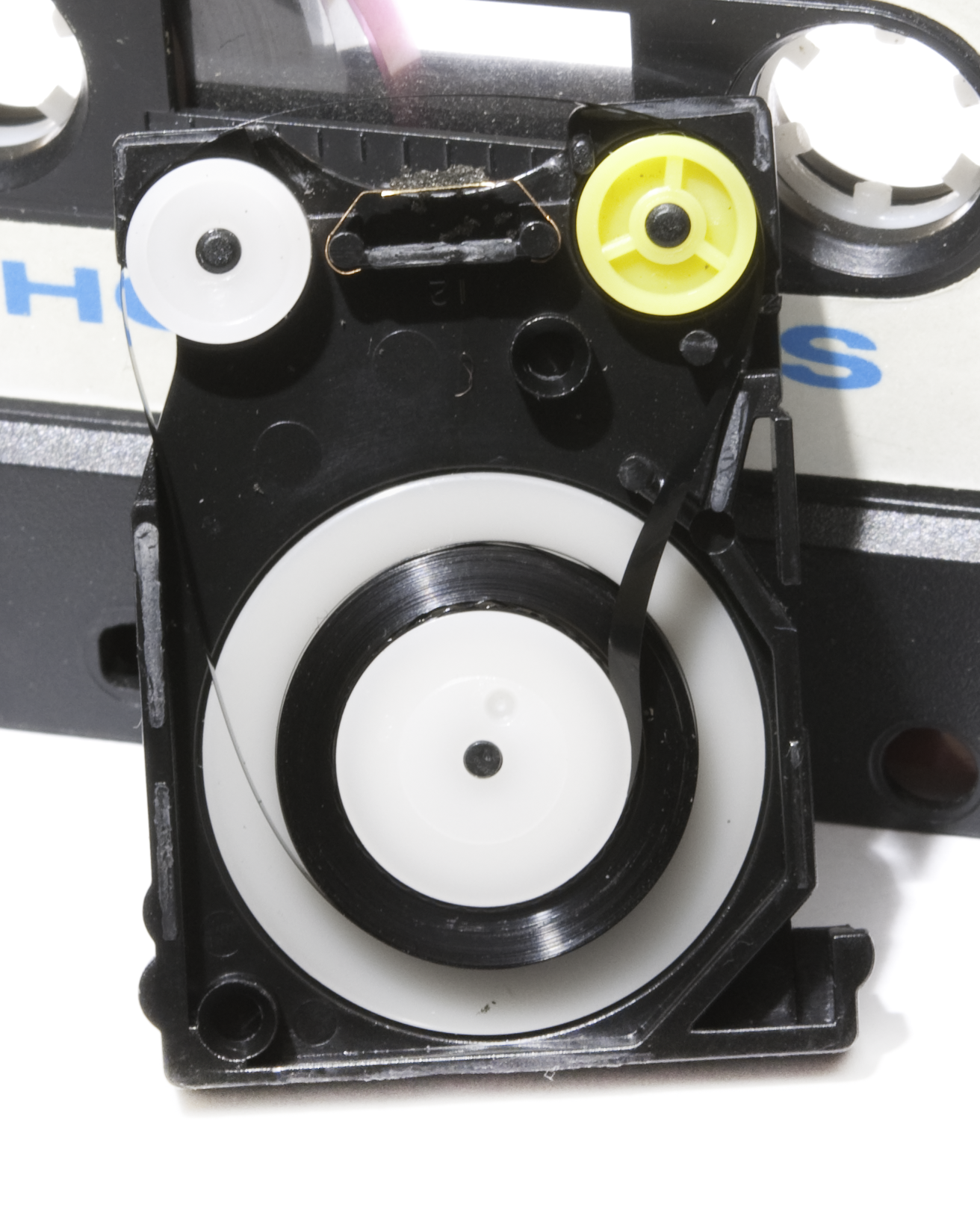 An opened ZX Microdrive cartridge showing its endless tape loop